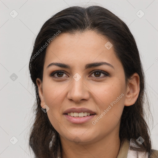 Joyful latino young-adult female with long  brown hair and brown eyes