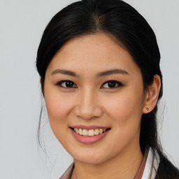 Joyful asian young-adult female with medium  brown hair and brown eyes