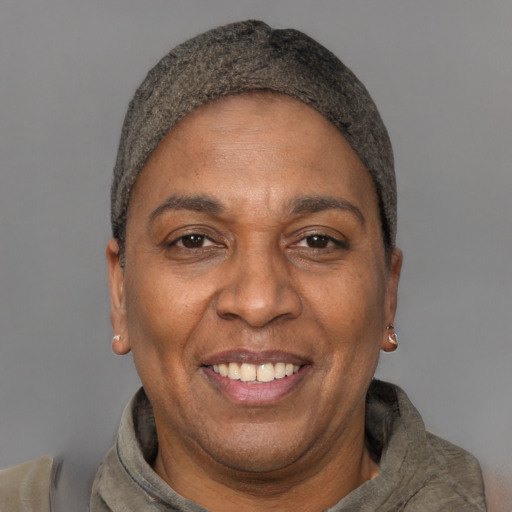 Joyful black adult female with short  black hair and brown eyes