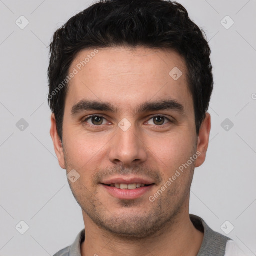 Joyful white young-adult male with short  black hair and brown eyes