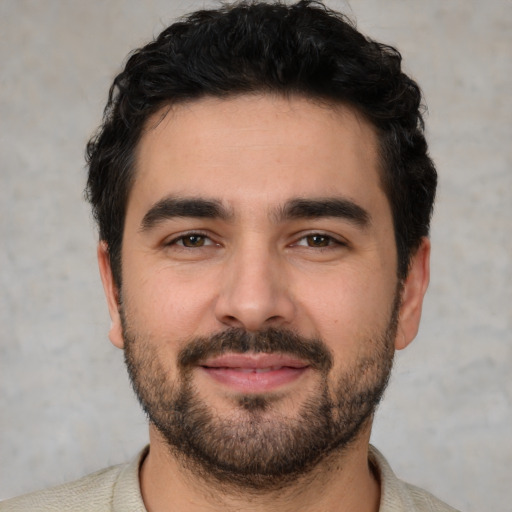 Joyful white young-adult male with short  black hair and brown eyes