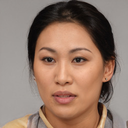 Joyful asian young-adult female with medium  brown hair and brown eyes