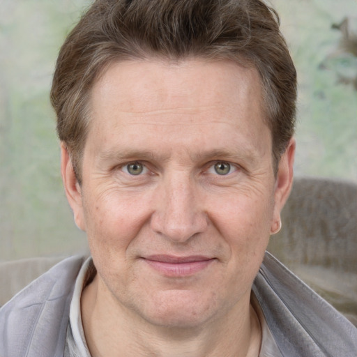 Joyful white adult male with short  brown hair and grey eyes