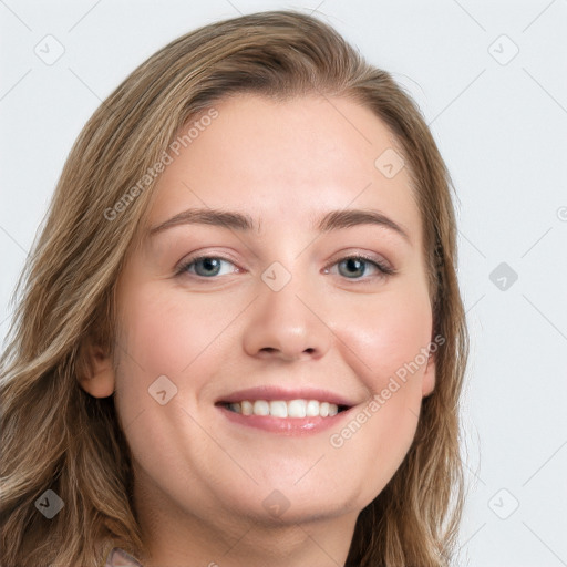 Joyful white young-adult female with long  brown hair and blue eyes