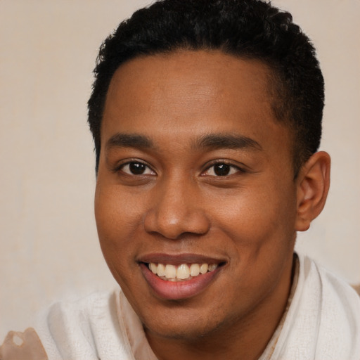 Joyful black young-adult male with short  brown hair and brown eyes