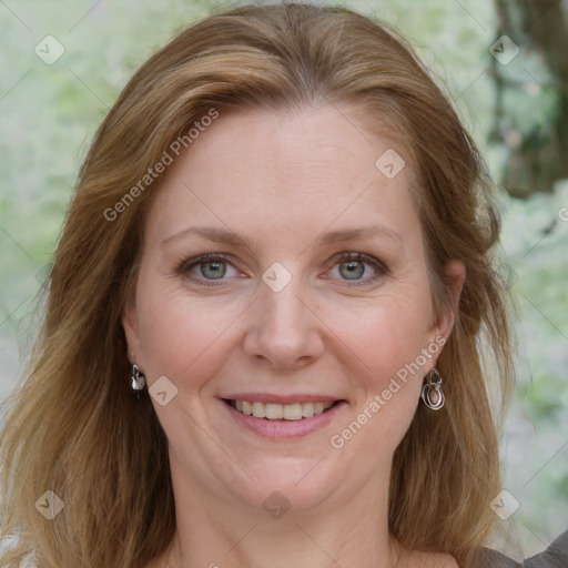 Joyful white adult female with medium  brown hair and blue eyes