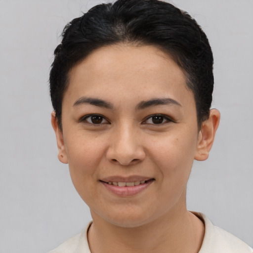 Joyful latino young-adult female with short  black hair and brown eyes