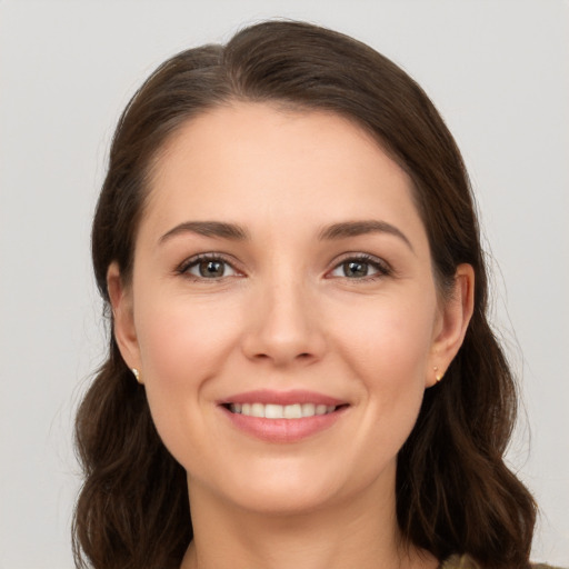 Joyful white young-adult female with long  brown hair and brown eyes