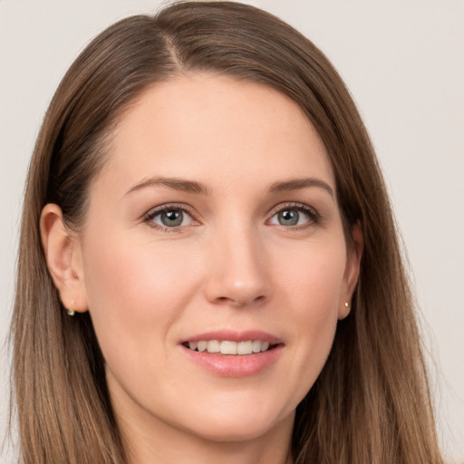 Joyful white young-adult female with long  brown hair and grey eyes