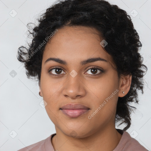 Joyful black young-adult female with long  black hair and brown eyes