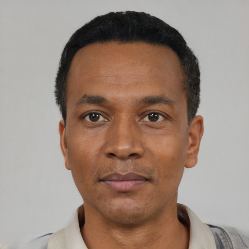 Neutral latino adult male with short  black hair and brown eyes