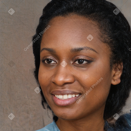 Joyful black young-adult female with long  black hair and brown eyes