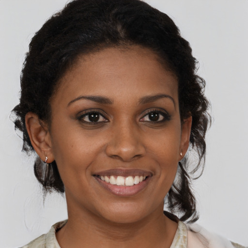 Joyful black young-adult female with medium  brown hair and brown eyes