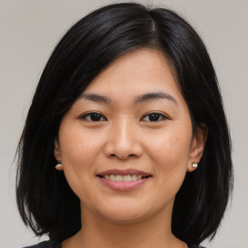 Joyful asian young-adult female with medium  black hair and brown eyes