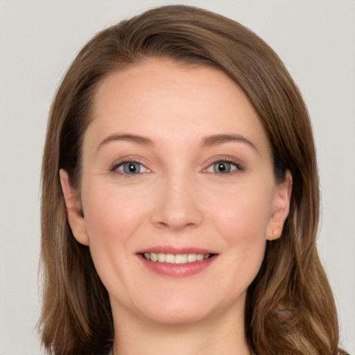 Joyful white young-adult female with long  brown hair and grey eyes