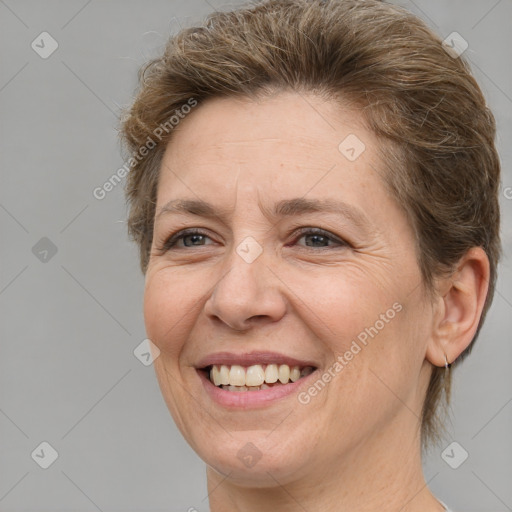 Joyful white adult female with medium  brown hair and brown eyes