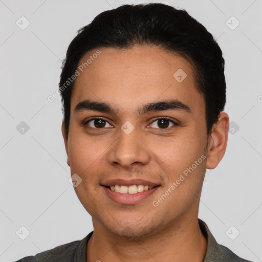 Joyful latino young-adult male with short  black hair and brown eyes