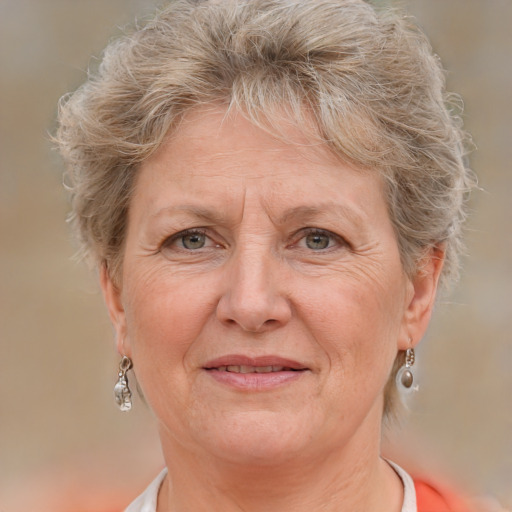 Joyful white middle-aged female with short  blond hair and grey eyes