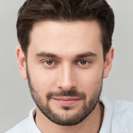 Joyful white young-adult male with short  brown hair and brown eyes