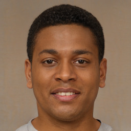 Joyful latino young-adult male with short  brown hair and brown eyes