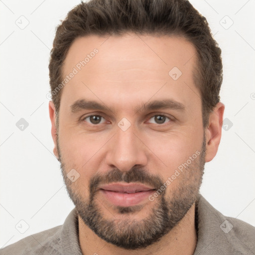 Joyful white adult male with short  brown hair and brown eyes