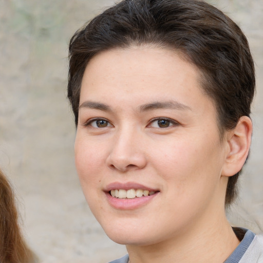 Joyful white young-adult female with short  brown hair and brown eyes