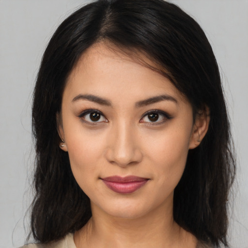 Joyful latino young-adult female with long  brown hair and brown eyes