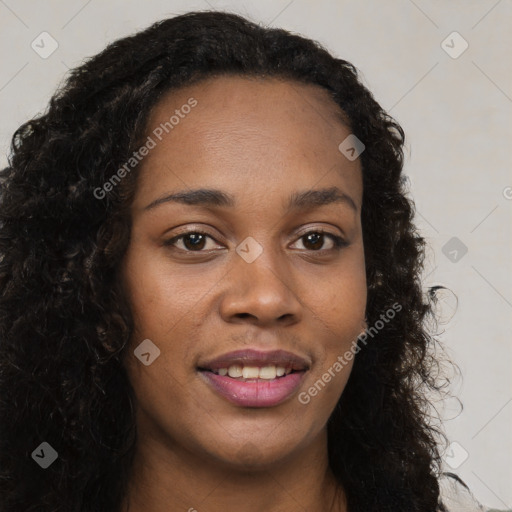 Joyful black young-adult female with long  brown hair and brown eyes