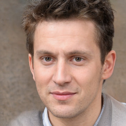 Joyful white adult male with short  brown hair and brown eyes