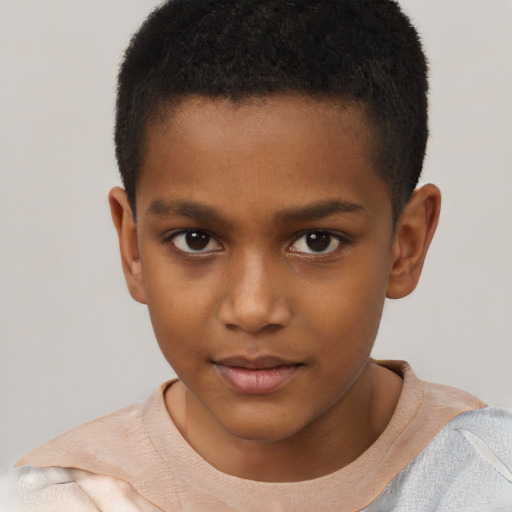 Joyful black child male with short  brown hair and brown eyes