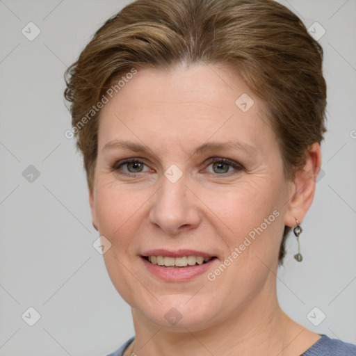 Joyful white adult female with medium  brown hair and blue eyes