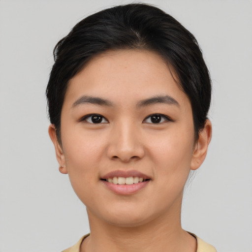 Joyful asian young-adult female with short  brown hair and brown eyes