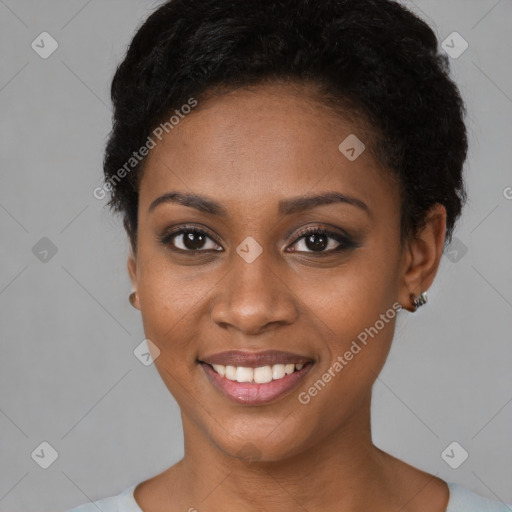 Joyful black young-adult female with short  black hair and brown eyes