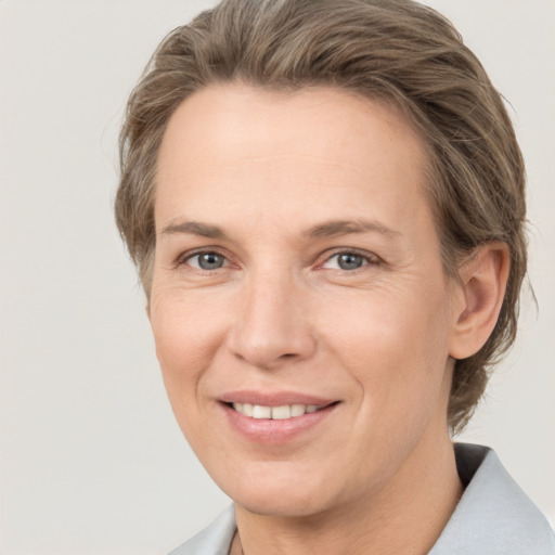 Joyful white adult female with short  brown hair and grey eyes