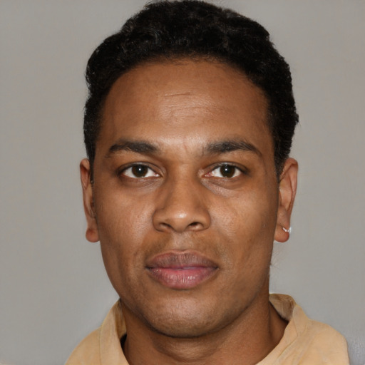 Joyful black young-adult male with short  black hair and brown eyes