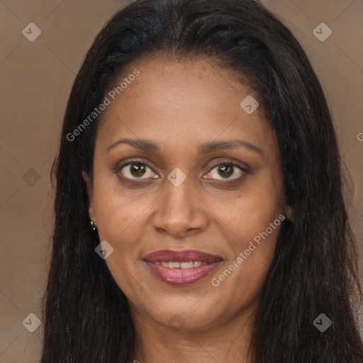 Joyful black adult female with long  brown hair and brown eyes