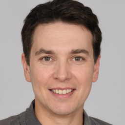 Joyful white adult male with short  brown hair and brown eyes