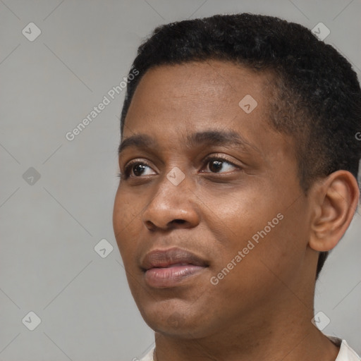 Joyful black young-adult male with short  black hair and brown eyes