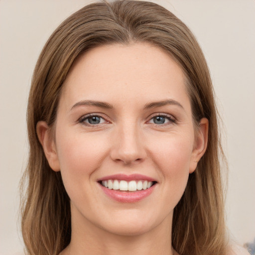 Joyful white young-adult female with medium  brown hair and grey eyes