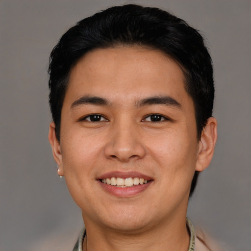 Joyful asian young-adult male with short  black hair and brown eyes