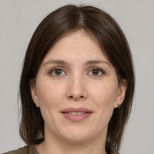 Joyful white adult female with medium  brown hair and brown eyes