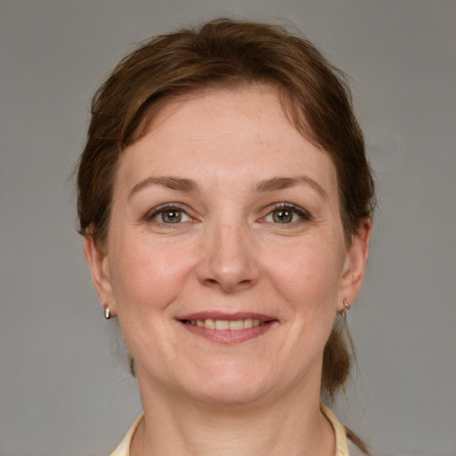 Joyful white adult female with medium  brown hair and grey eyes