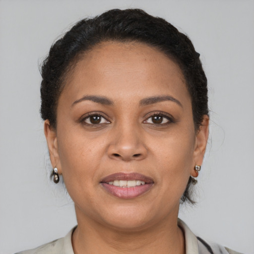 Joyful latino young-adult female with short  brown hair and brown eyes