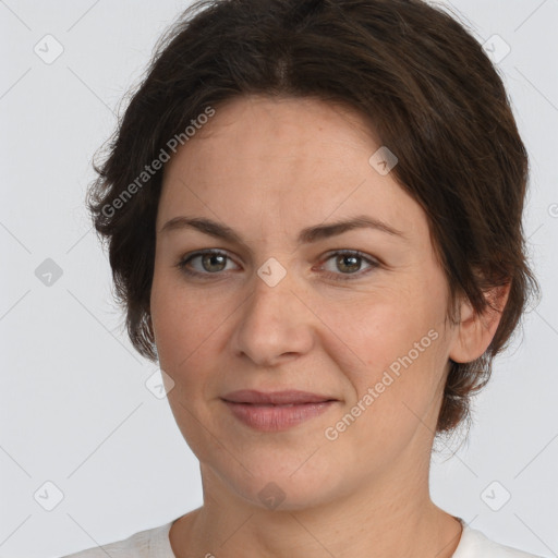 Joyful white adult female with short  brown hair and brown eyes