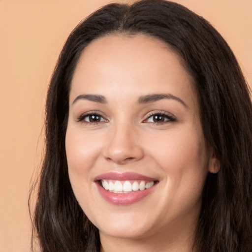 Joyful white young-adult female with long  brown hair and brown eyes