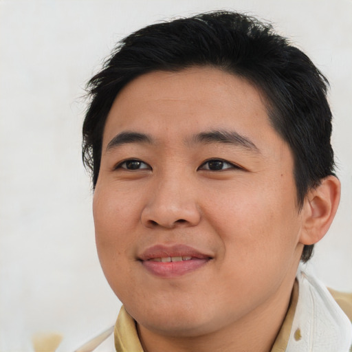 Joyful asian young-adult male with short  brown hair and brown eyes
