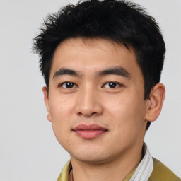 Joyful asian young-adult male with short  black hair and brown eyes