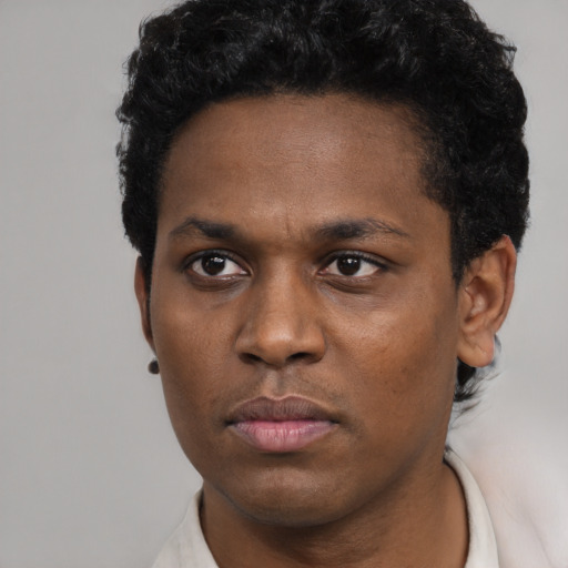 Neutral black young-adult male with short  black hair and brown eyes