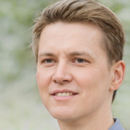 Joyful white adult male with short  brown hair and brown eyes