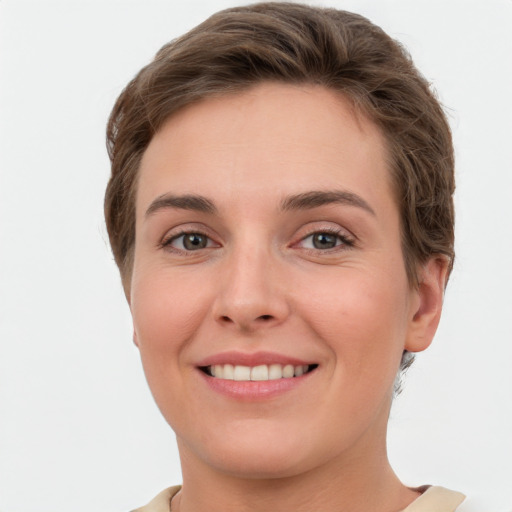 Joyful white young-adult female with short  brown hair and grey eyes